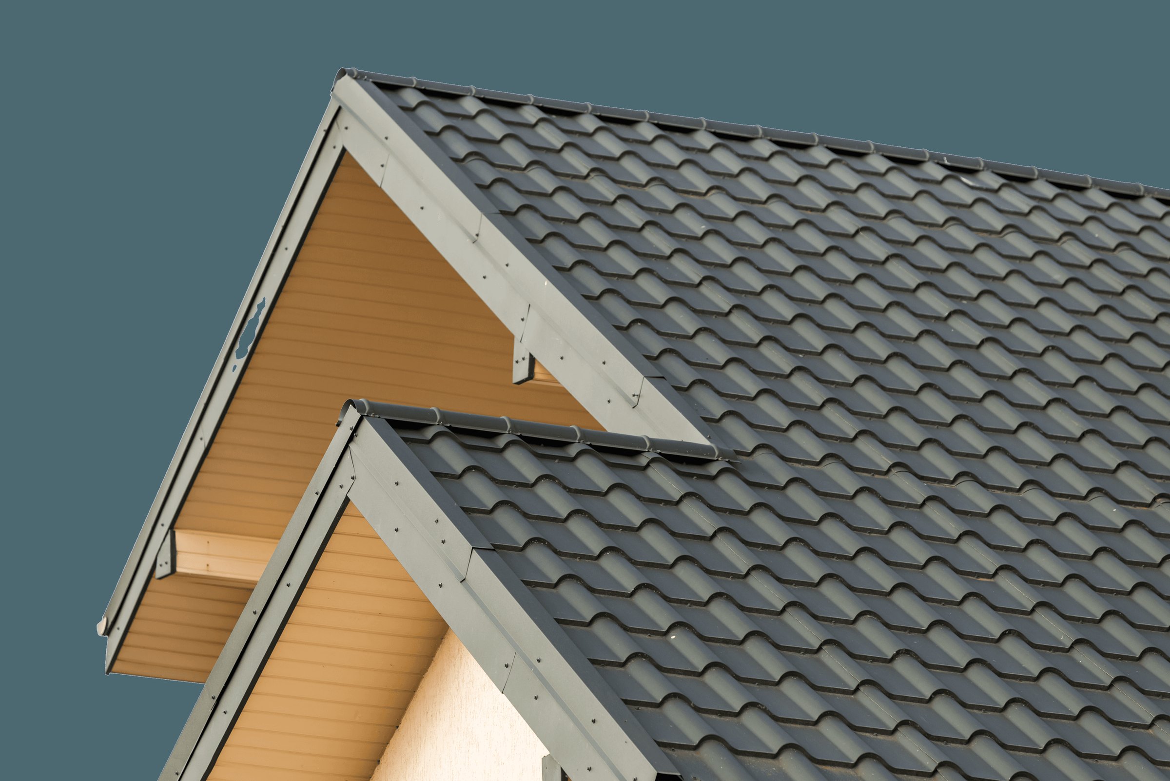 Steep tiled roof against a clear sky